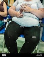 Obese woman sitting on chair hi-res ...